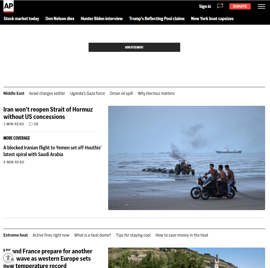 AP News homepage featuring a coastal scene with people riding a motorcycle near fishing boats and ships at sea.