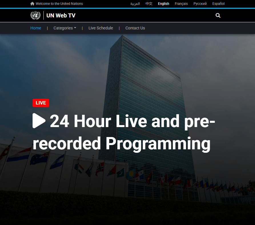 UN Web TV homepage showing the United Nations Headquarters building with national flags and a “24 Hour Live and pre-recorded Programming” banner.